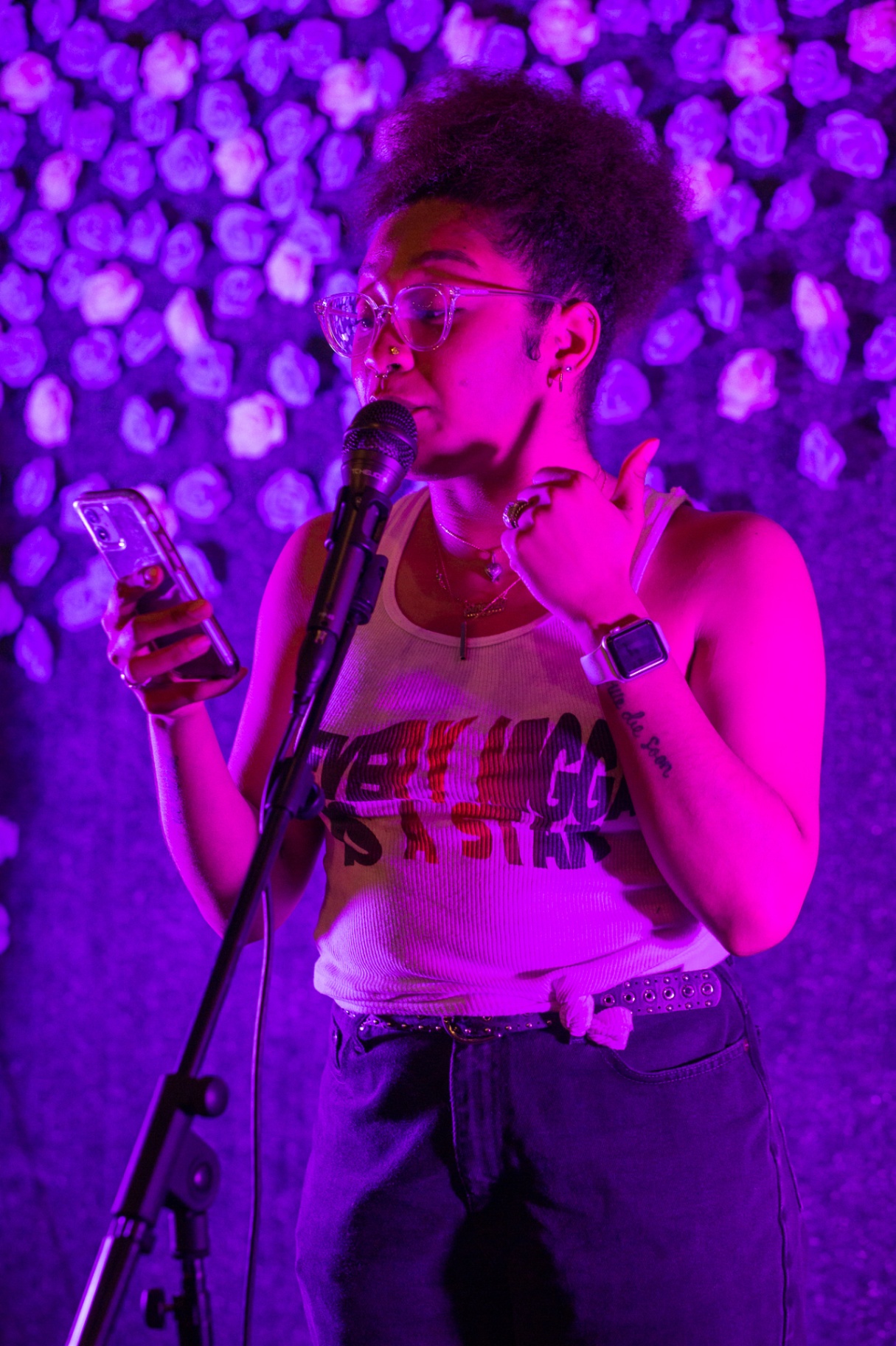 Poet reading from phone at Hues Cookout 2022