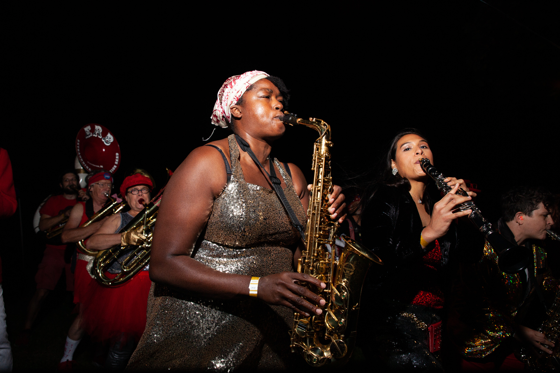 Brass and woodwind musicians performing together at Hues Picnic 2021
